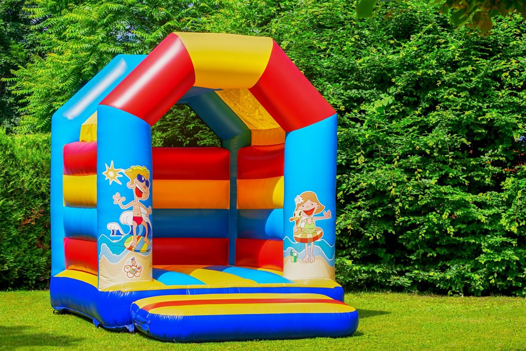 bouncy castle jump house inflatable colorful on grass